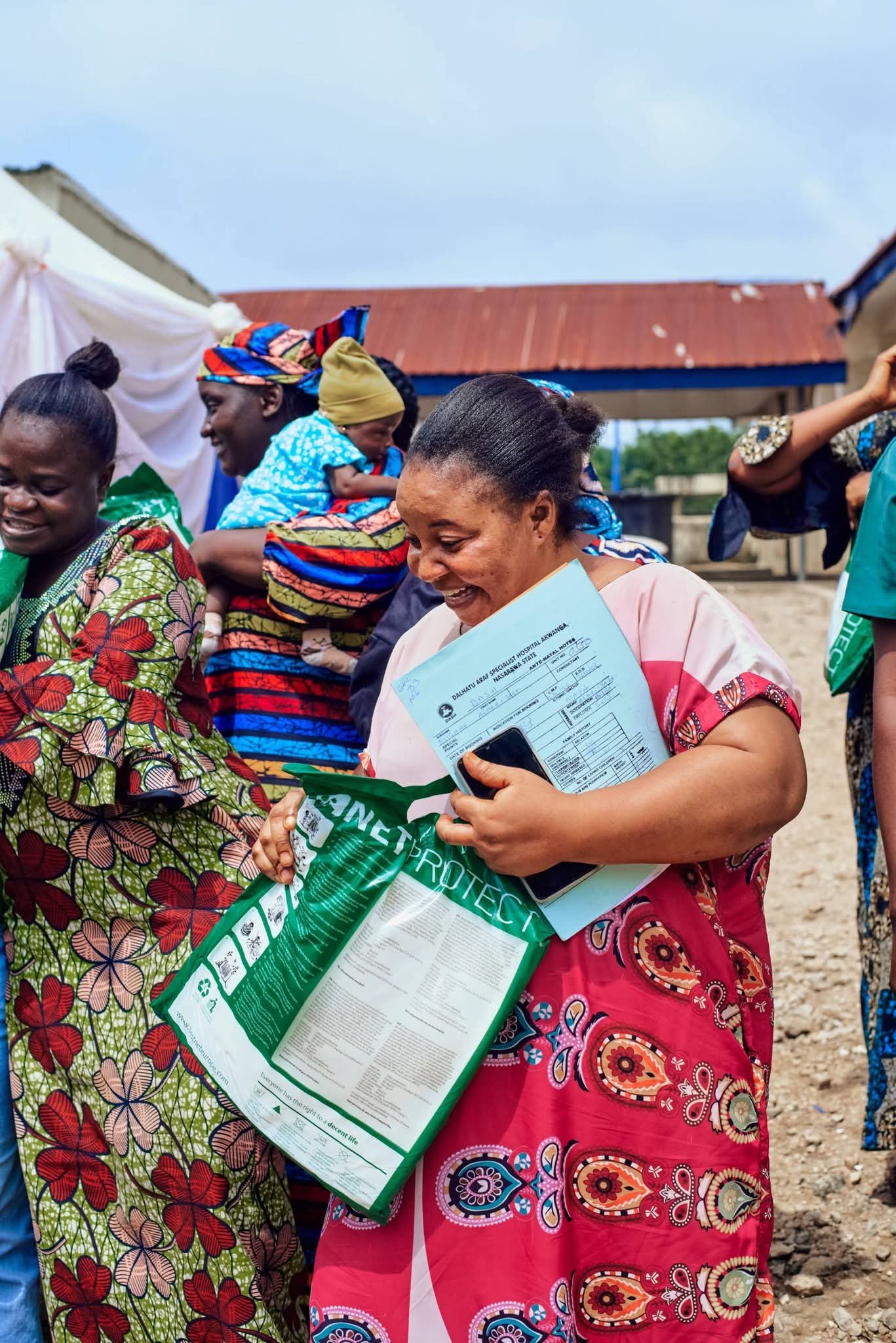 Woman holding an outreach package and supplies.