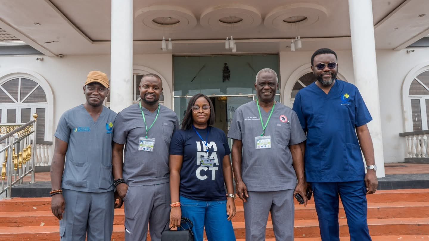 Five outreach team members stand together outside a building in Ibadan.