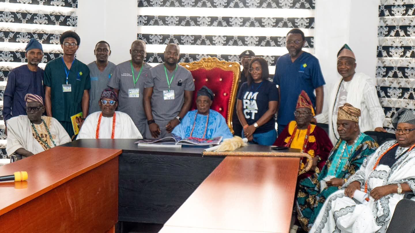 Outreach partners meet traditional leaders beside a ceremonial chair.
