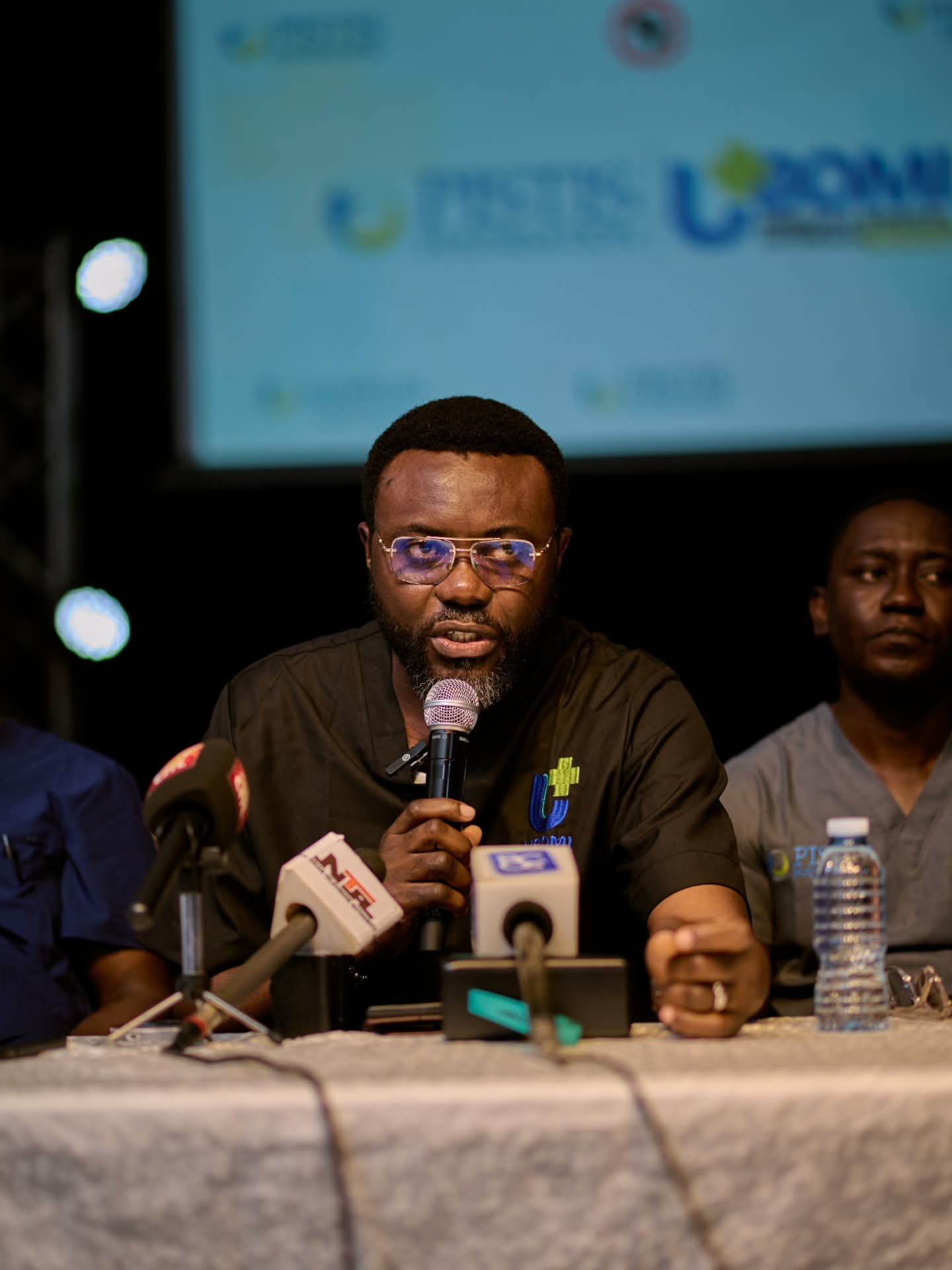 A UBOMI representative speaks at a press conference.