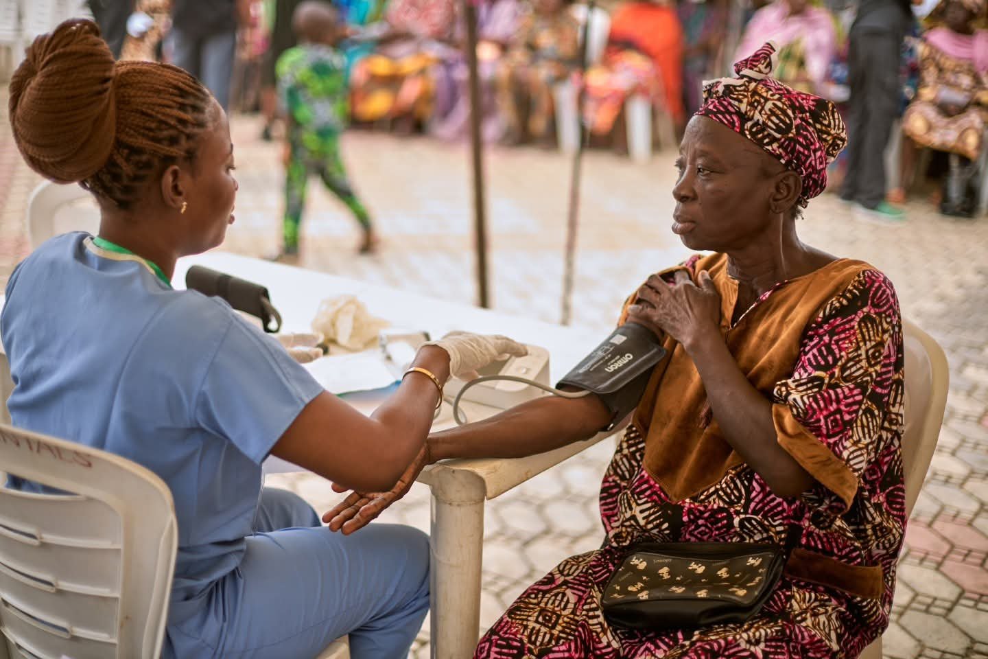 A nurse measures an older woman’s blood pressure.